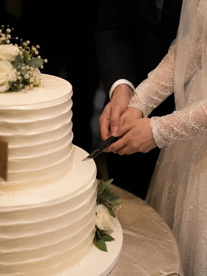 The couple cutting their wedding cake
