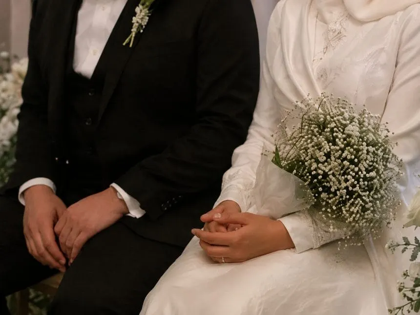 The couple seated together during the ceremony